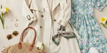 Spring wardrobe essentials flat lay with trench coat, floral dress, and accessories.
